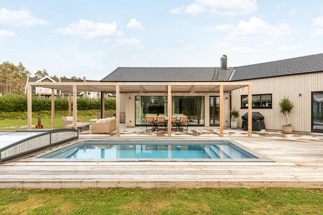 Ljuvlig utemiljö med stor pool och plats för flera möblemang