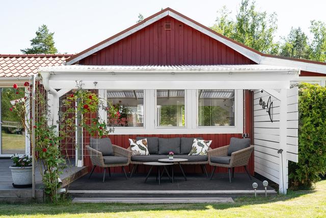 Uteplats under tak på baksidan av huset.