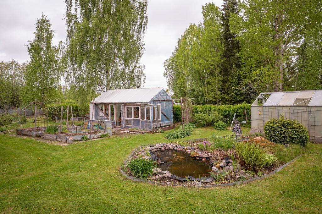 Växthus och damm i trädgården