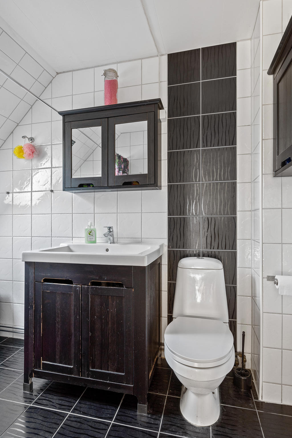 Helkaklat badrum på det övre planet med golvvärme, badkar och wc samt tvättställ och kommod 