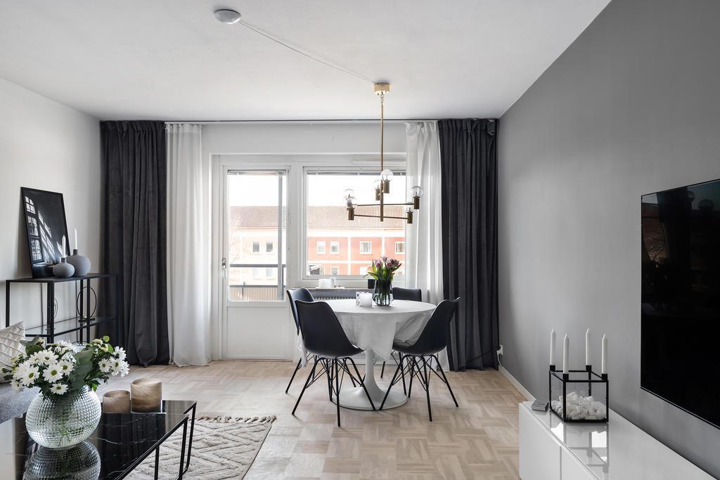 Ljust och rymligt vardagsrum med utgång till bostadens balkong. Här finns gott om utrymme för socialt umgänge.