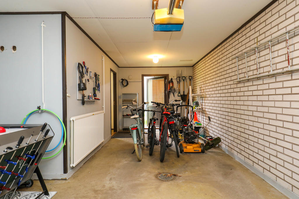 Garage med dörr direkt till trädgården på baksidan.