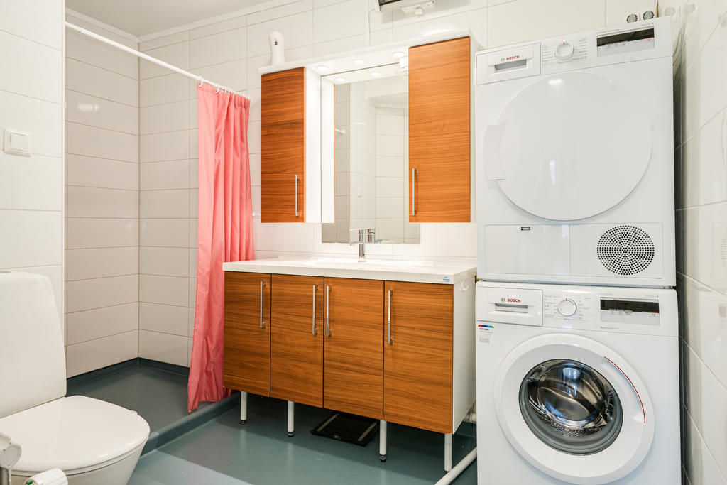 Renoverat badrum med tvättmaskin och torktumlare. 