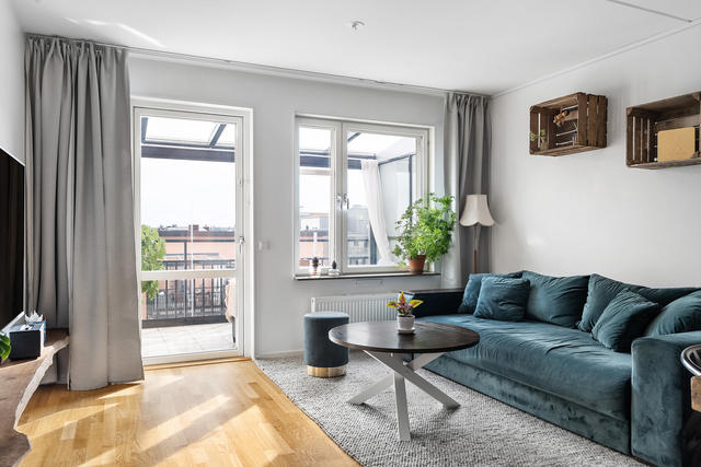 Vardagsrum med utgång till lägenhetens ena inglasade balkong