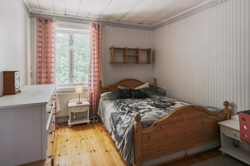 Sovrum med klädkammare och vacker kakelugn med härd av Kinnekullesten. 