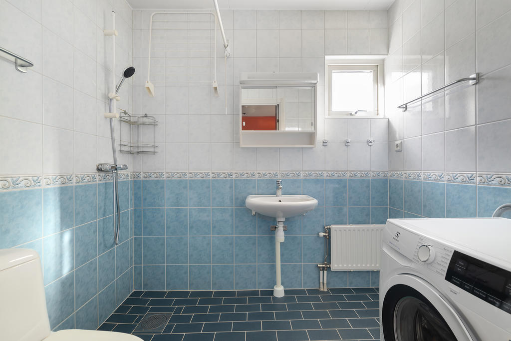 Helkaklat badrum med tvättmaskin