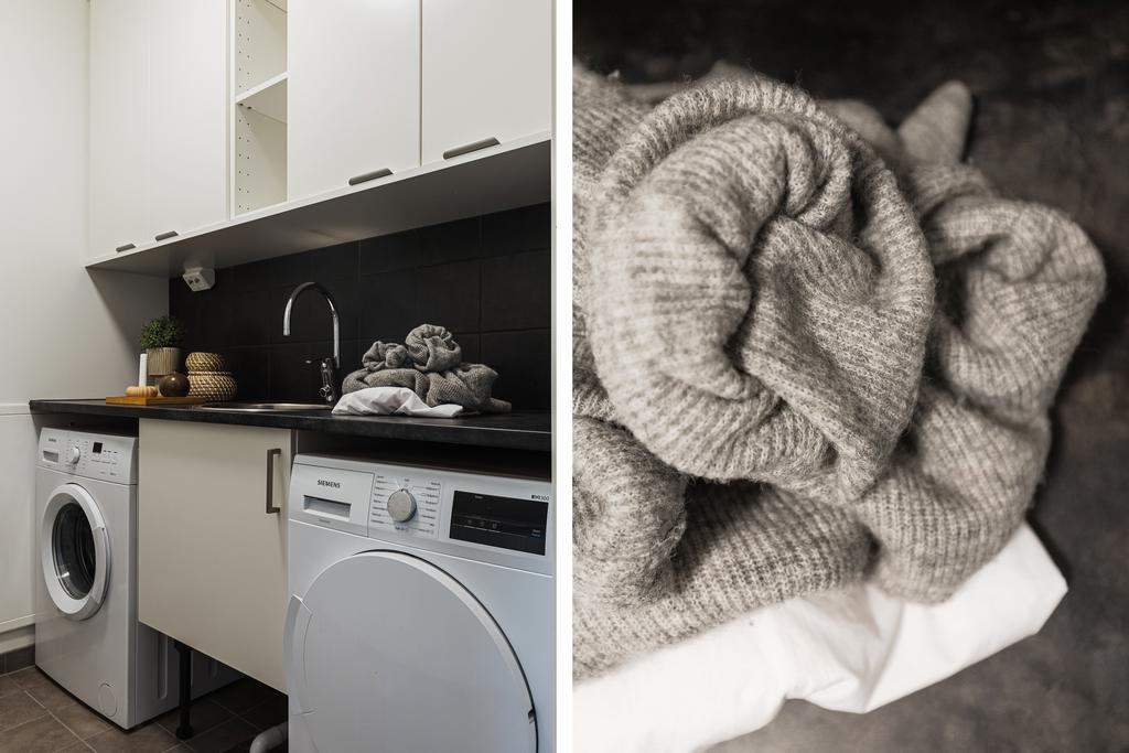 Separat tvättstuga med skåp, bänk och ho