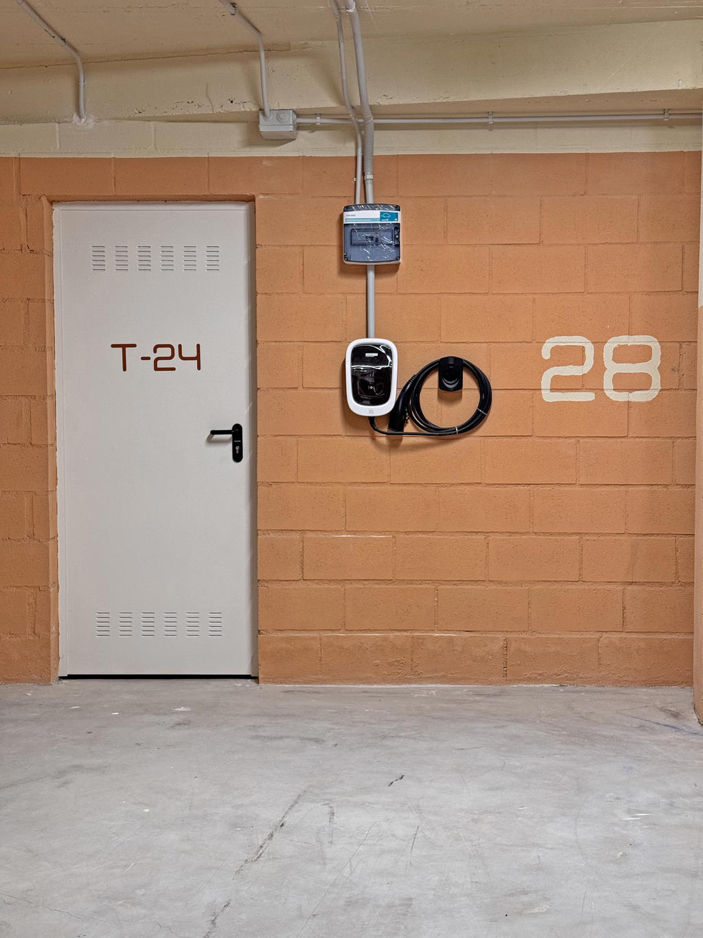 Parking space with electric car charging station.