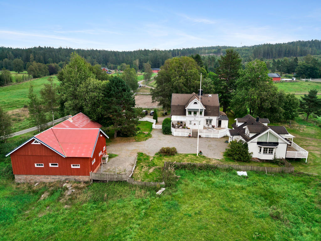 Två boningshus, ladubyggnader, dubbelgarage och ridbana.