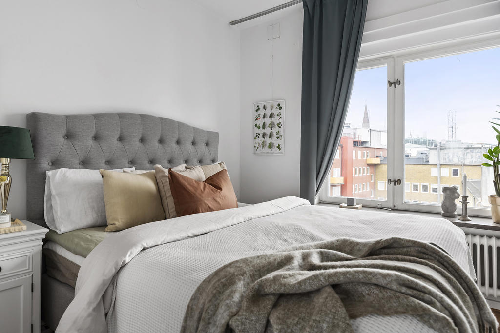 Sovrum med plats för dubbelsäng och kompletterande förvaringslösningar.