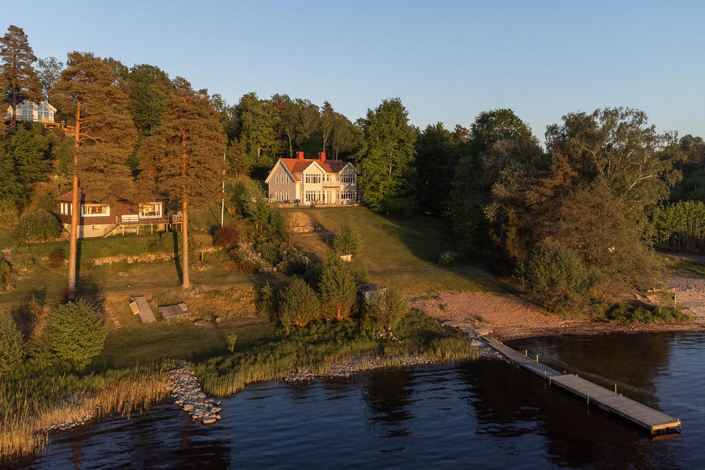 Översiktsbild där man ser egna sandstranden och bryggan.