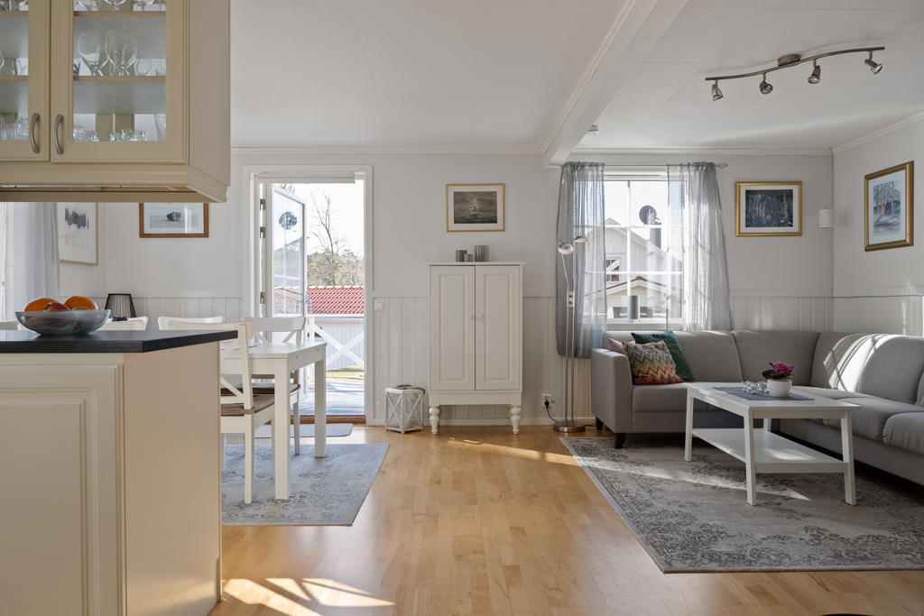 Det luftiga vardagsrummet erbjuder en öppen och ljus atmosfär, perfekt integrerat med kök och matsalsplats. En elegant kamin tillför både charm och värme till rummet.
Här finns även gott om plats för TV.