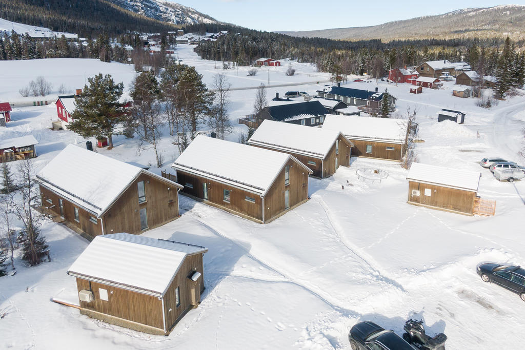 Fyra fjällstugor och två attefallshus med trädgård och tillhörande parkering