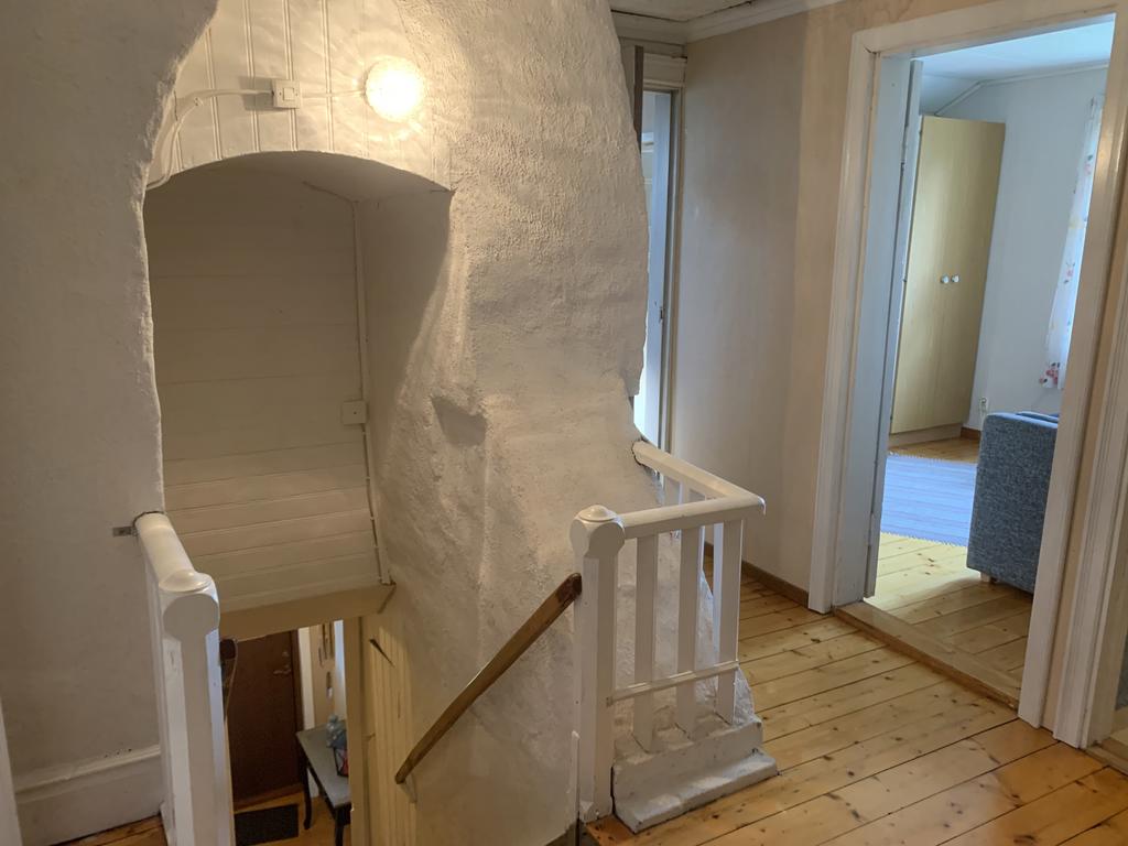 Unikt trapphus som går igenom/mellan två murstockar upp till övervåningen. 