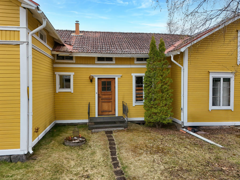 Entré i öster. Bostadshus och ekonomibyggnad är ihopdockade och entrén är i tillbyggnaden mellan dessa två. 