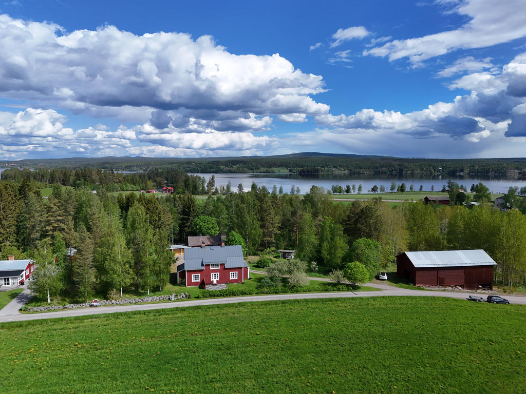 Vy över tomten med Ljusnan i bakgrunden. 