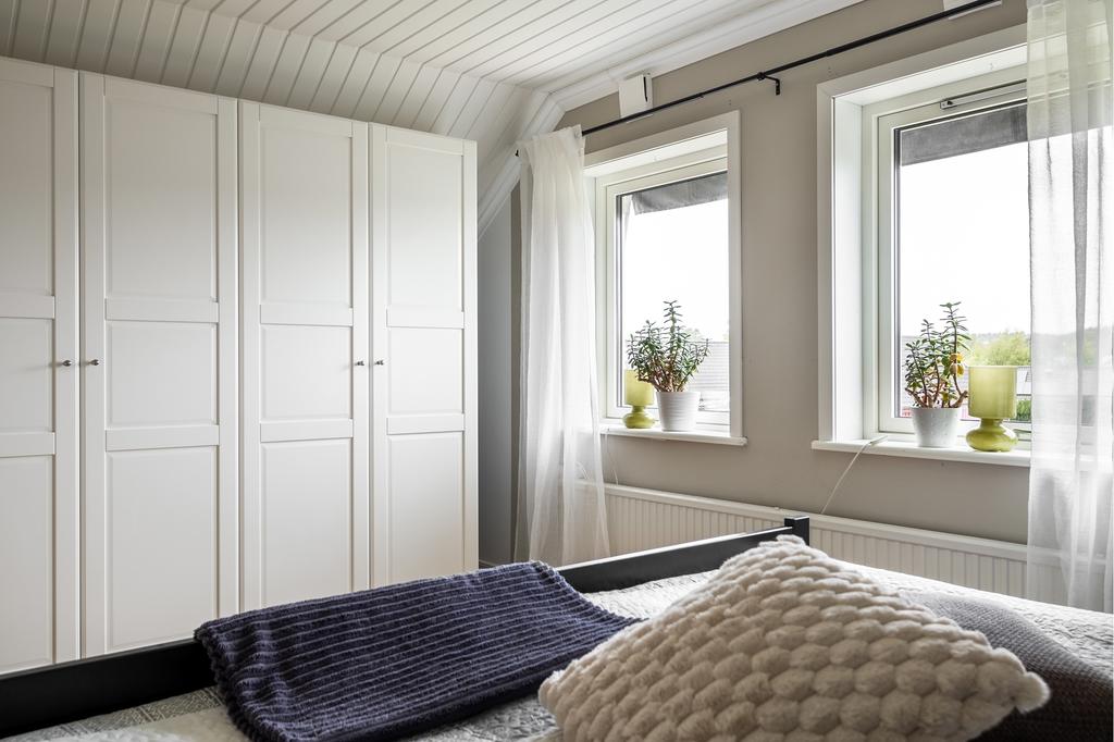 Imponerande garderobsvägg, vilket garanterar utmärkt förvaring och skapar en organiserad och stilfull atmosfär i detta smakfullt designade rum.
