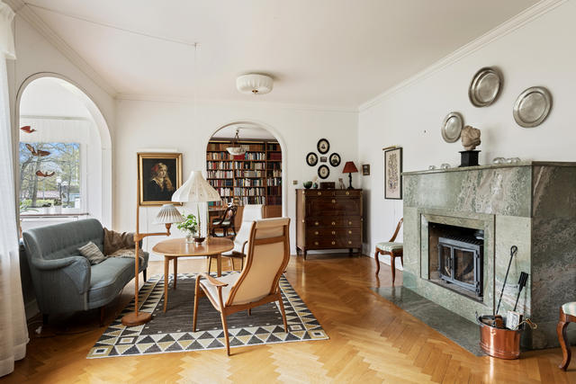 Salongen med blomsterrummet. Den öppna spisen är klädd i grönskimrande Kolmårdsmarmor