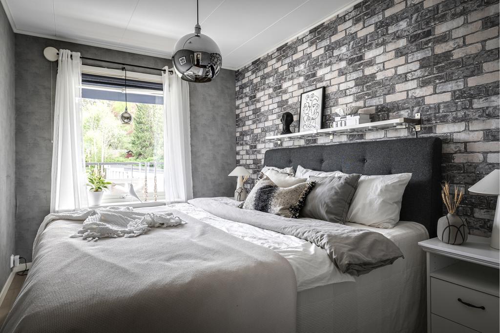 Bostadens tredje sovrum, även detta i gråton med en fondtapet med fint ljusinsläpp från fönstret.