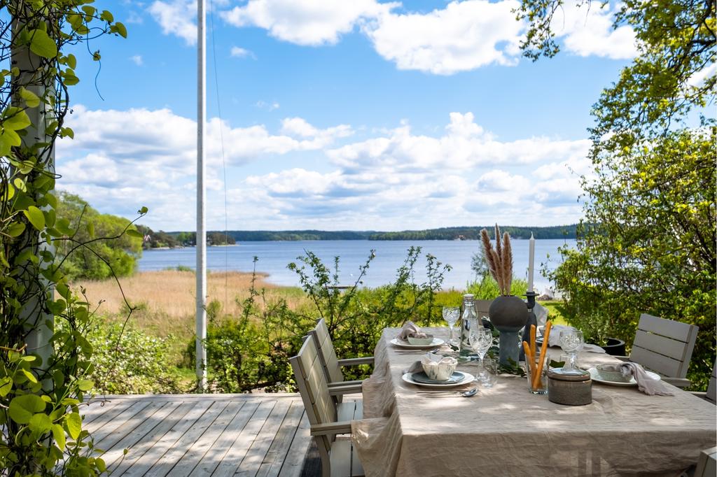 Den stora soldränkta altanen inbäddad i den lummiga trädgården.