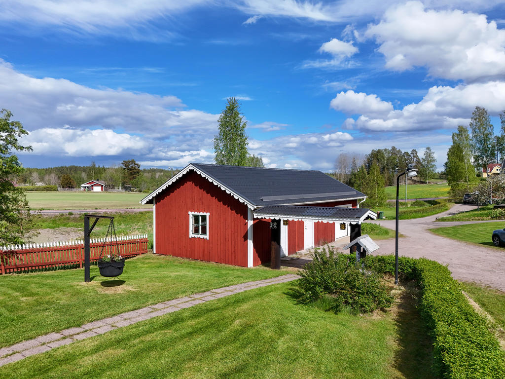Vy från gårdstunet mot garage och infart till tomten. 