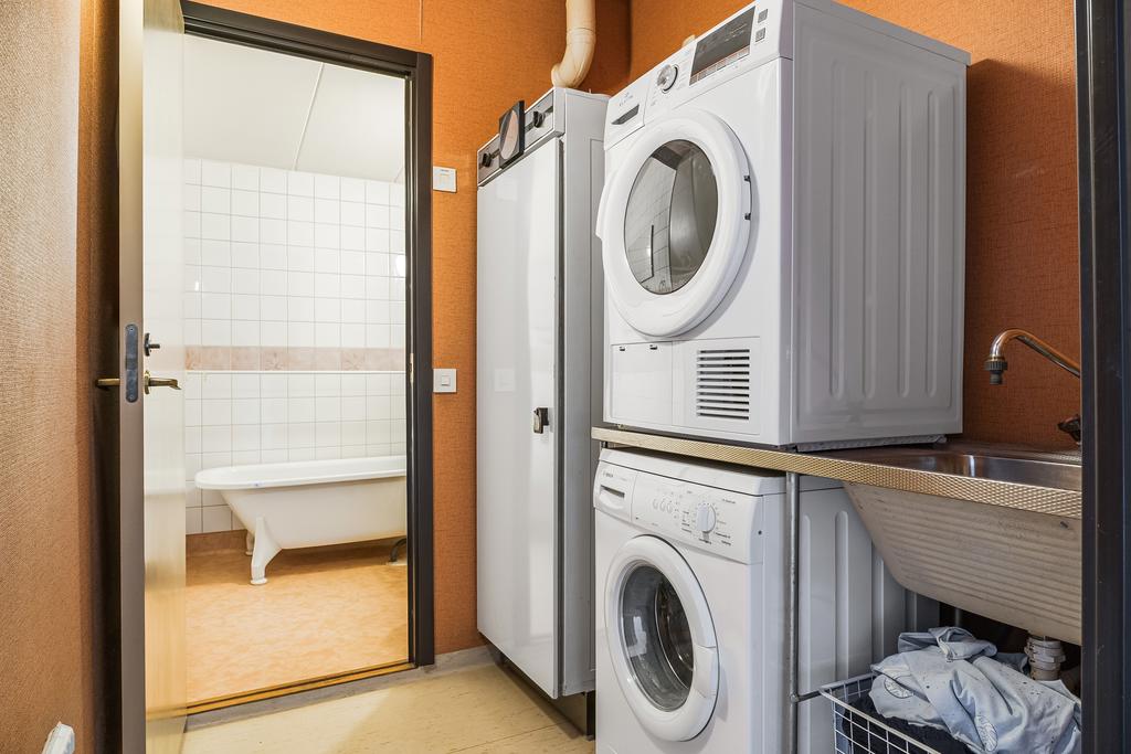 Tvättavdelning med tvättmaskin, torktumlare och torkskåp