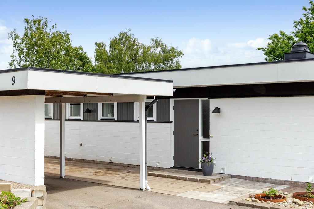 Infarten är rymlig och tydligt avgränsad med carport och förråd