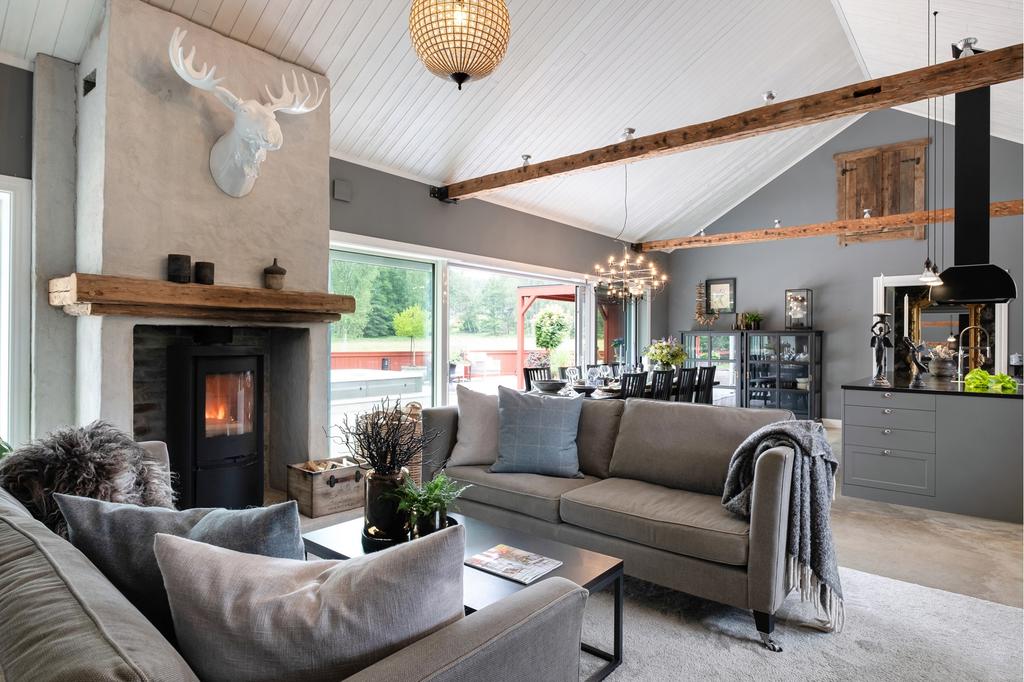 Det rymliga vardagsrummet erbjuder en elegant atmosfär med braskamin 