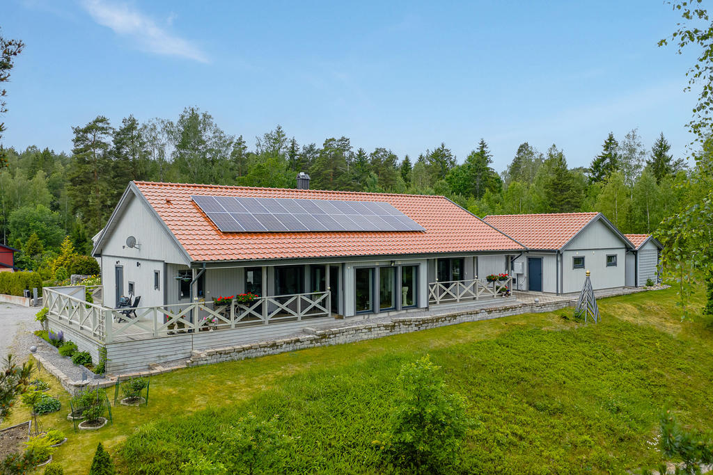 Huset med sina stora altaner och med solceller - från sjösidan