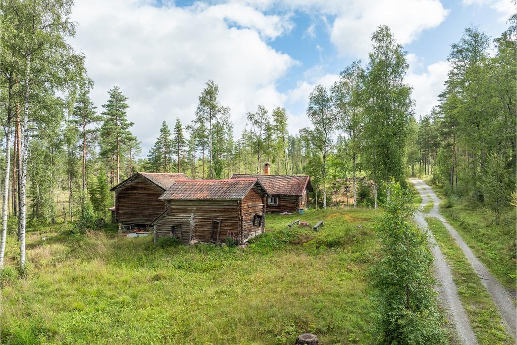 Idyllisk fäbodmiljö med timrade byggnader.