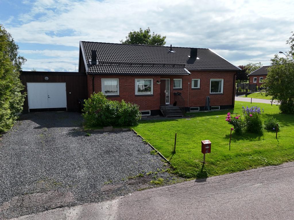 Här finns vidbyggt garage med elbilsladdare. 