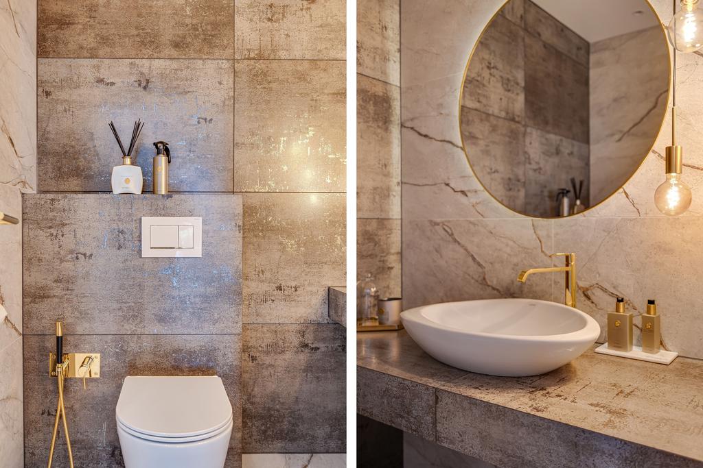 Stilrent och modern wc varm stenkänsla, vägghängd wc och modern belysning.