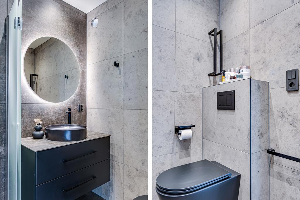Sovrummets eget badrum har en modern stil med grå och svart färgsättning.