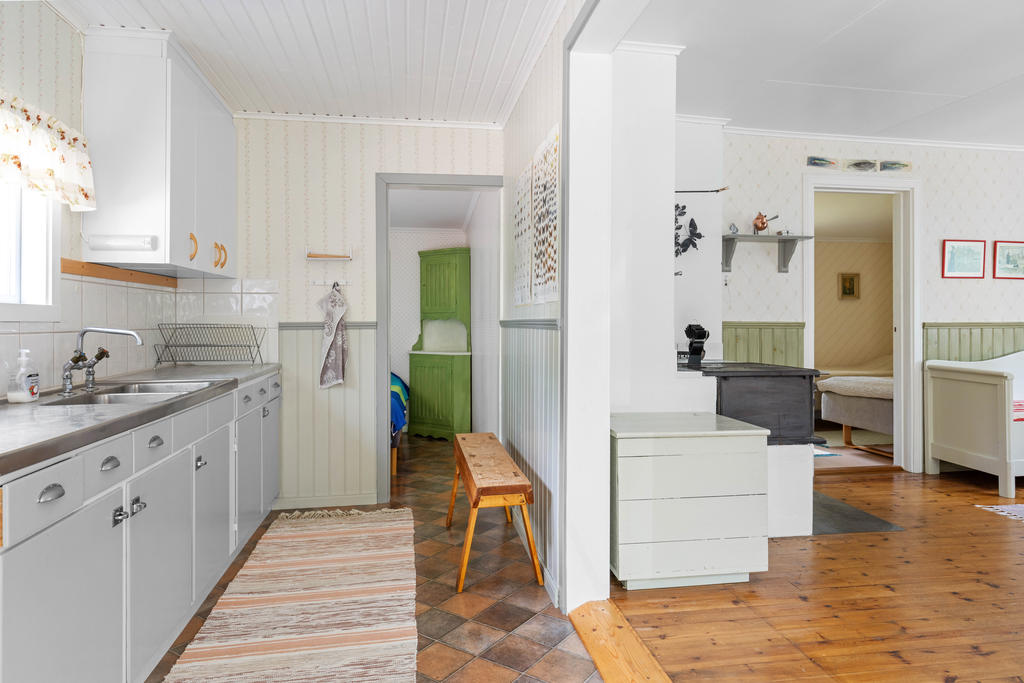 Vy från entrén direkt in till kök och öppen planlösning till allrum. 