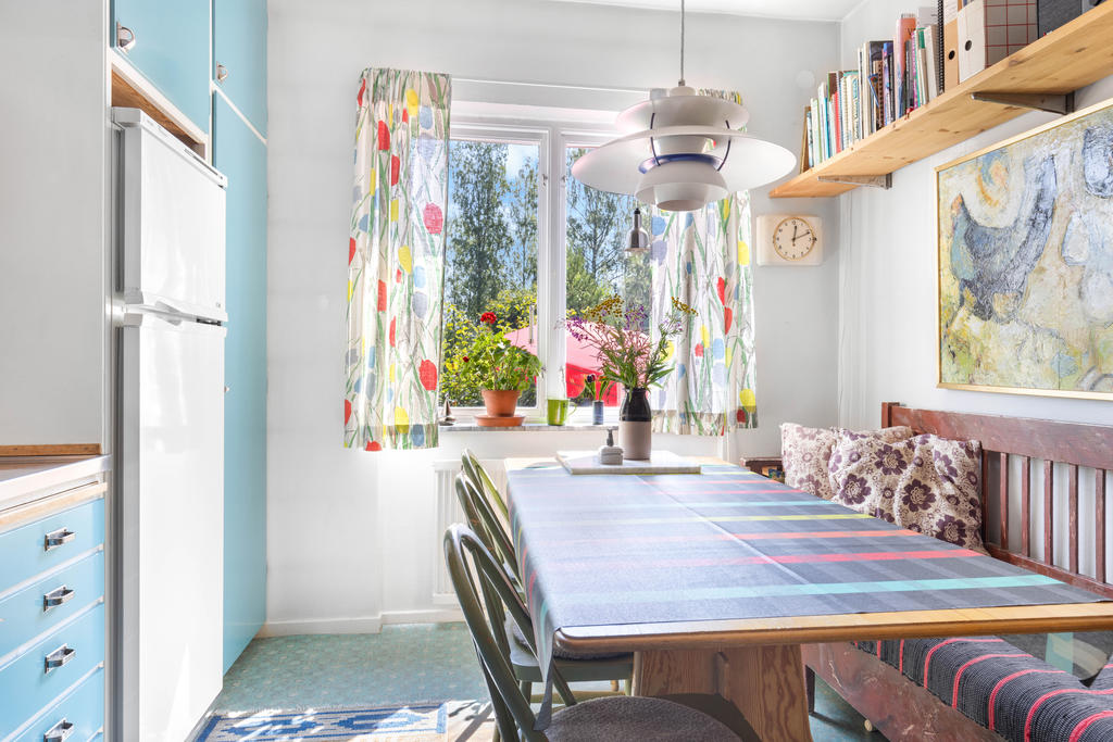 Kök med plats för matbord och kökssoffa. 