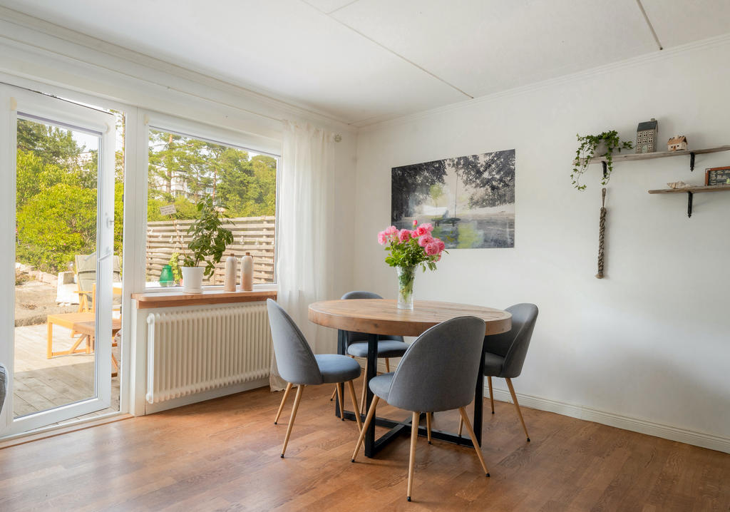 Vardagsrum med plats för matbord och utgång till den fina baksidan