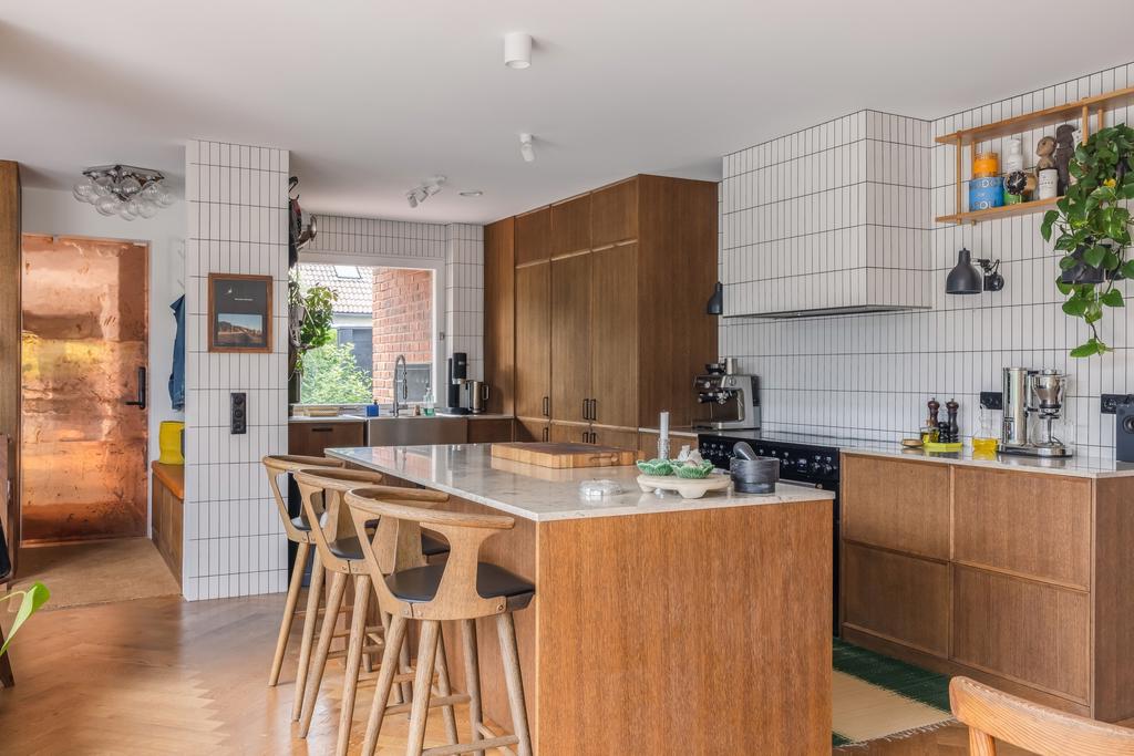 Socialt och smakfullt kök i mörk ek där träets djupa ton ger köket en varm och sofistikerad känsla