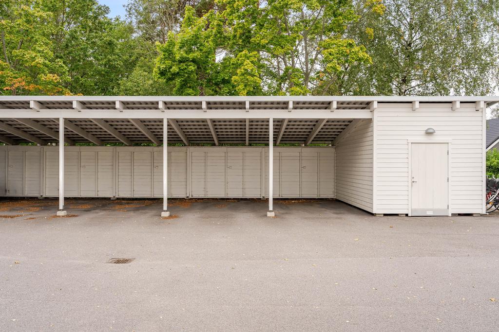 Parkeringsplats med tak precis intill huset 