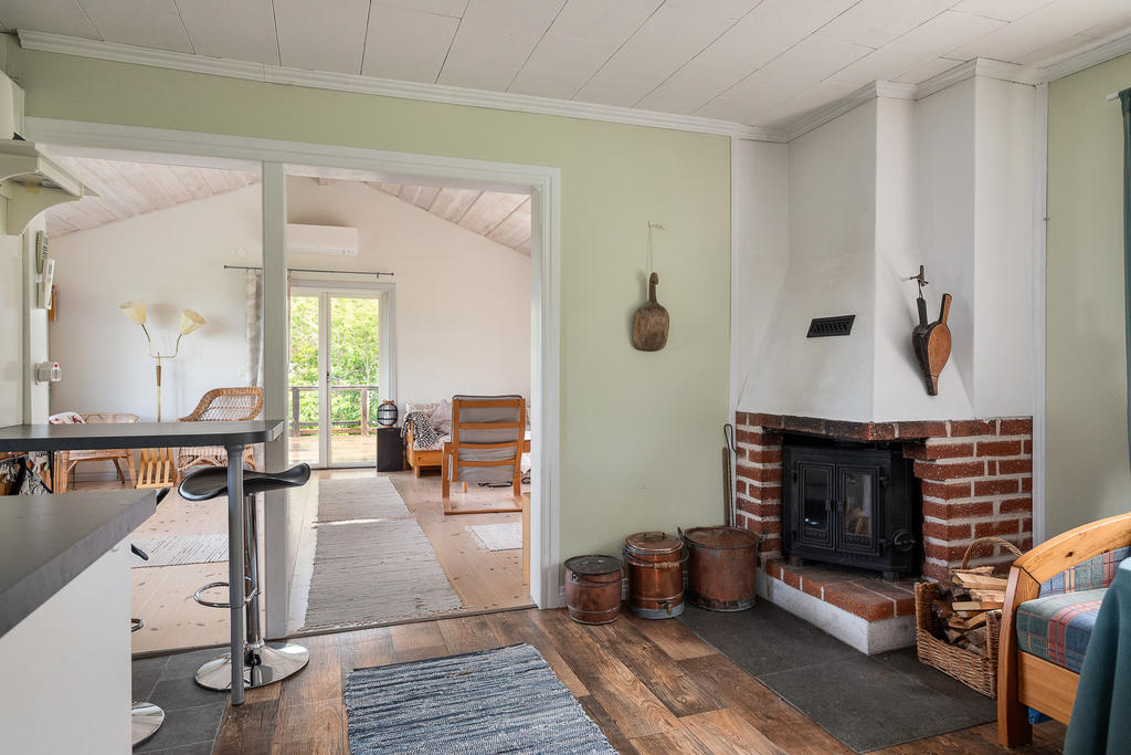 Mitt i huset finns en öppen spis med kassett för att sprida värme och trivsel