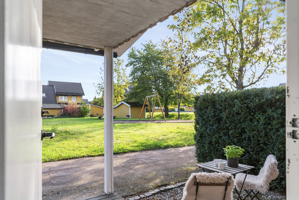 På husets framsida blickar man ut över grönområde och lekplats.