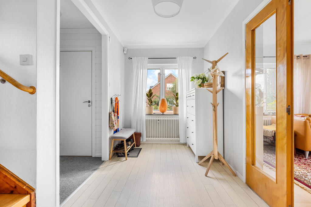Möblerbar inre hall med pardörrar i glas in till vardagsrummet