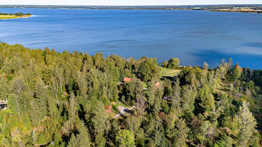 Tomten om 2,8 ha sträcker sig från landsvägen ner till sjön