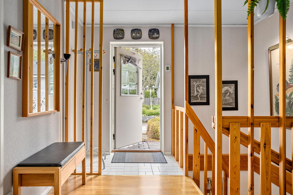 Välkommen in! Hall med klinkers och plats för ytterkläder och skor