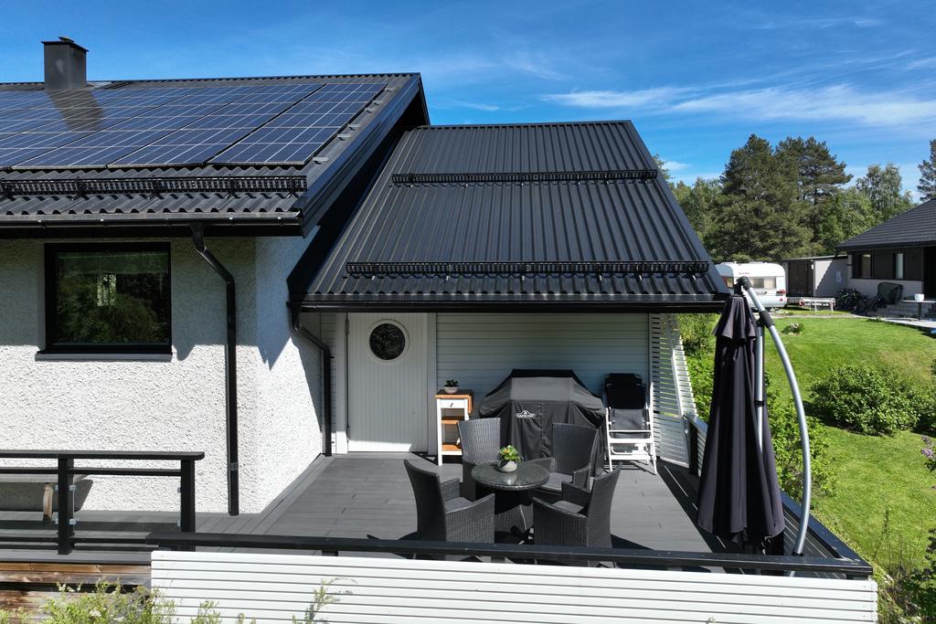 Altanen bakom garage och carporten har anslutning till trädgården