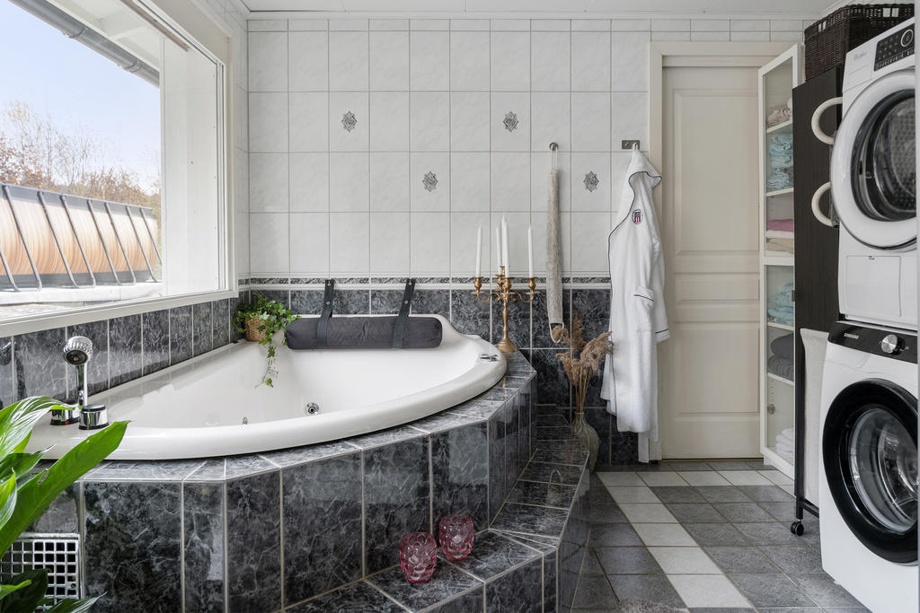 Har både duschkabin och badkar samt tvättavdelning