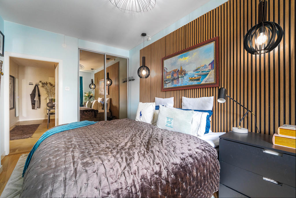 Sovrum med praktisk inbyggd skjutdörrsgarderob.