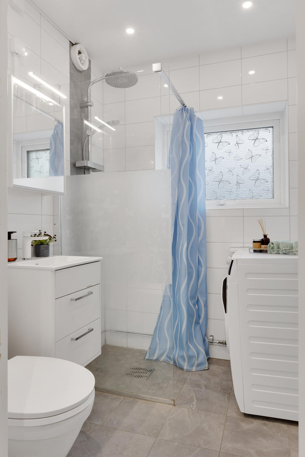 Helkaklat badrum med tvättmaskin som renoverades 2018