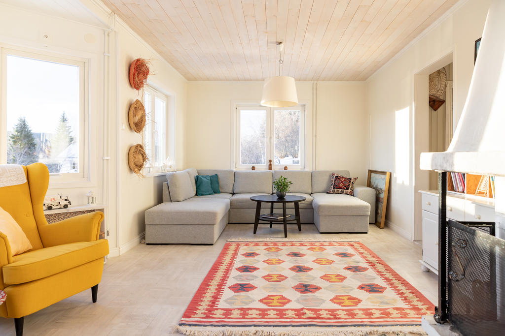 Matplats och soffhörna i öppen planlösning med vacker öppen spis i centrum