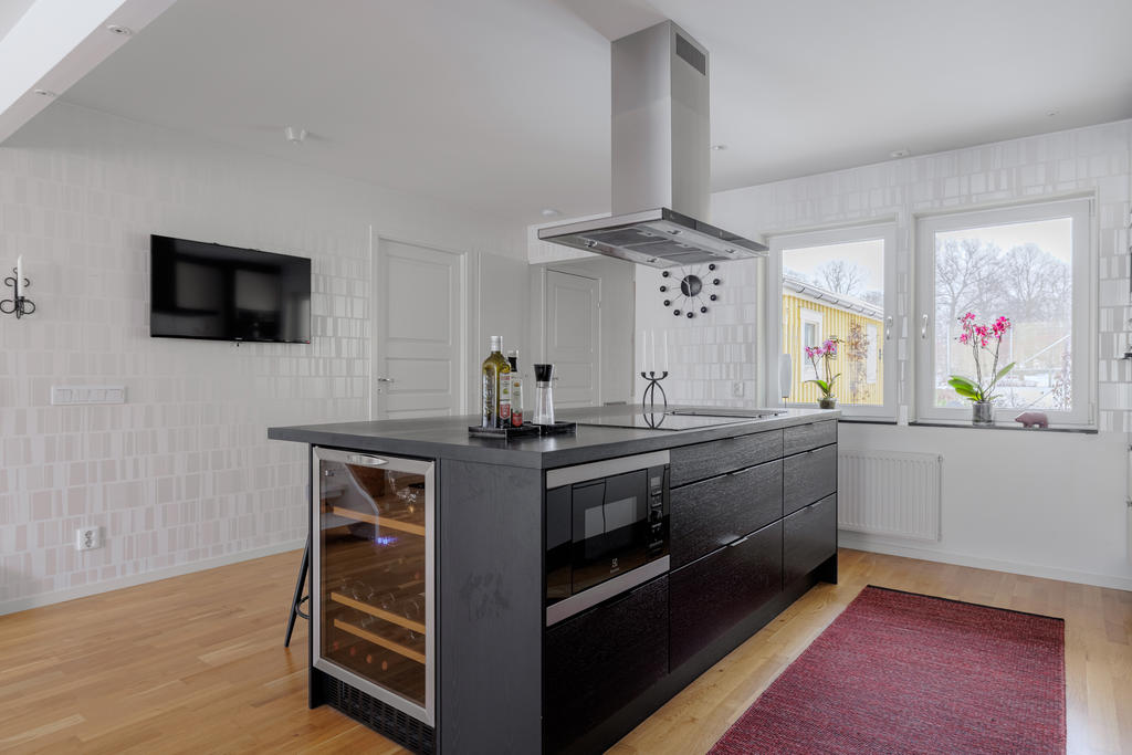 Köksö med såväl förvaring, sittplatser, vinkyl, micro och induktionshäll