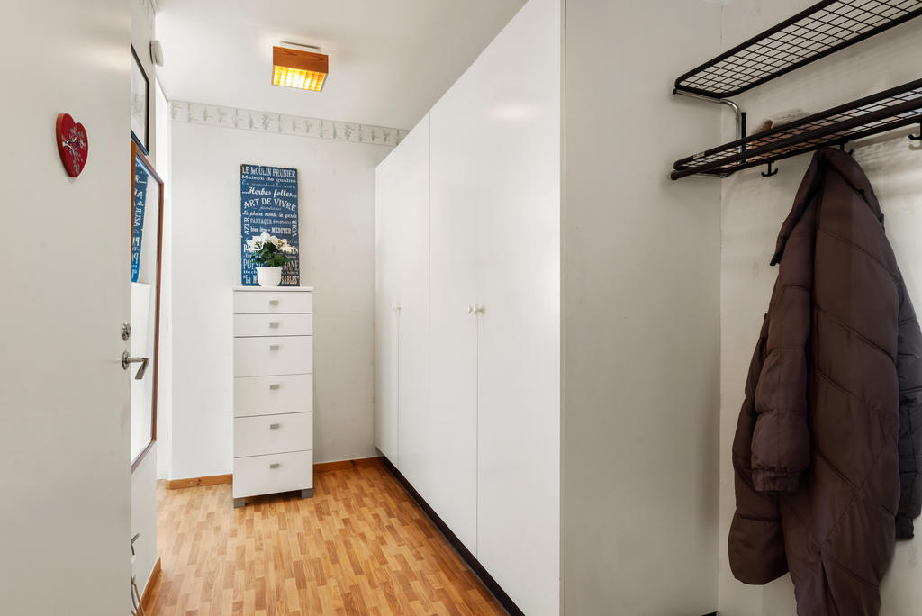 Hall med fyra garderober och plats för ytterkläder. 